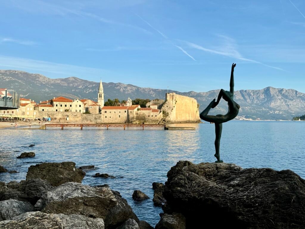 The Budva Dancing Girl Statue with Budva Old Town in the Background